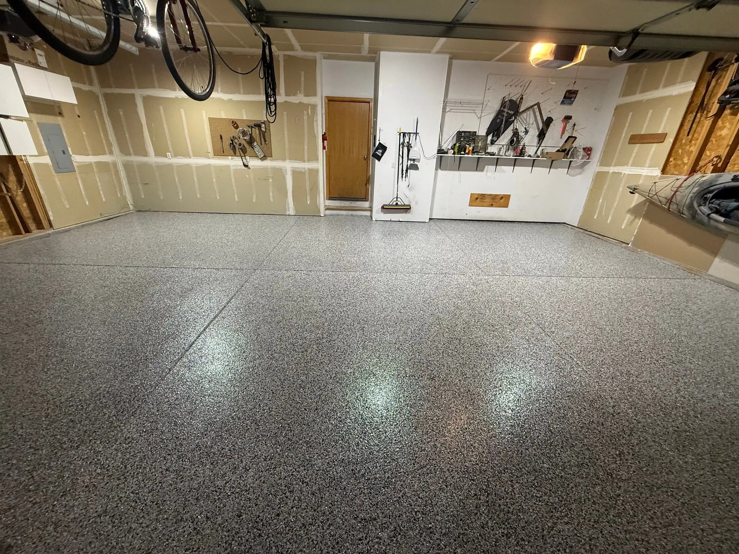 Garage after Epoxy Flake: gray full-broadcast flake floor with a glossy topcoat